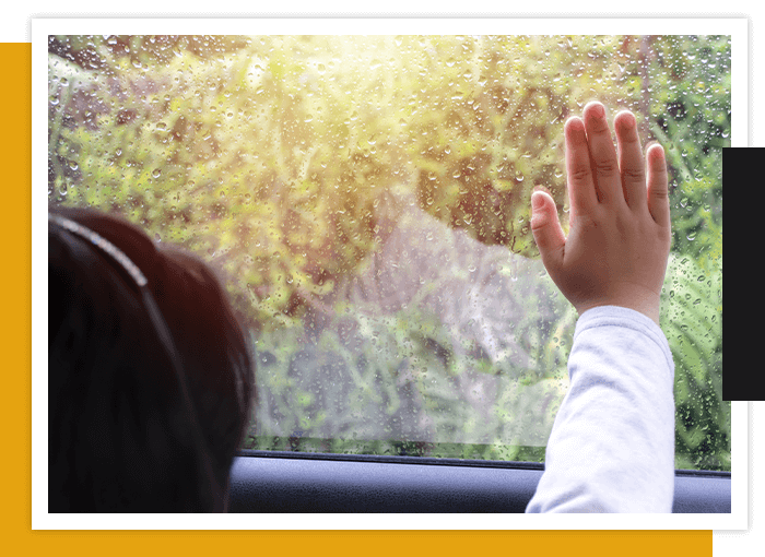 UV (1) young girl looking out and touching car window
